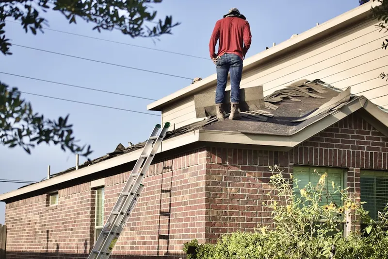 Professional roofer working on a residential roof in Yale Park
